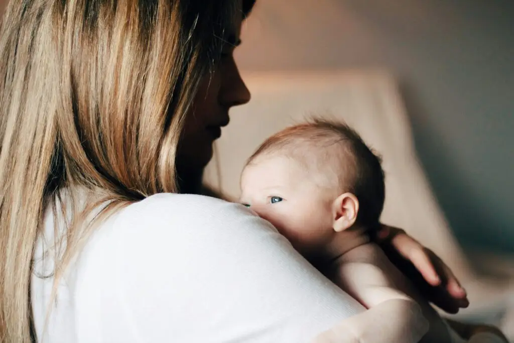 postpartum mom holding baby depicting: Postpartum Mental Health: When More Support Is Needed